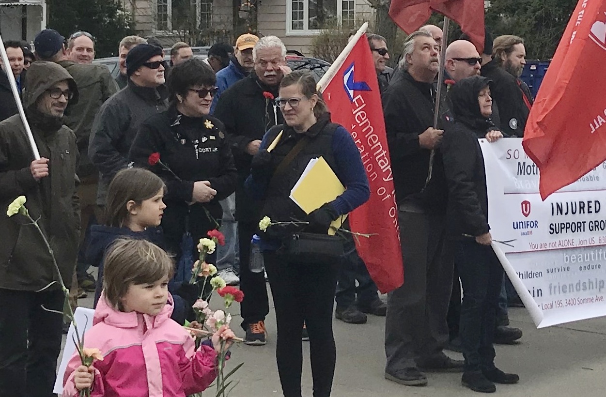 Laura Chesnik holding a flag at Windsor National Day of Mourning for workers killed or injured while on the job. April 28,2018