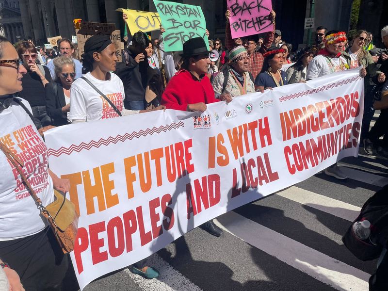 Demonstrators at Climate Strike hold signs demanding climate justice NYC