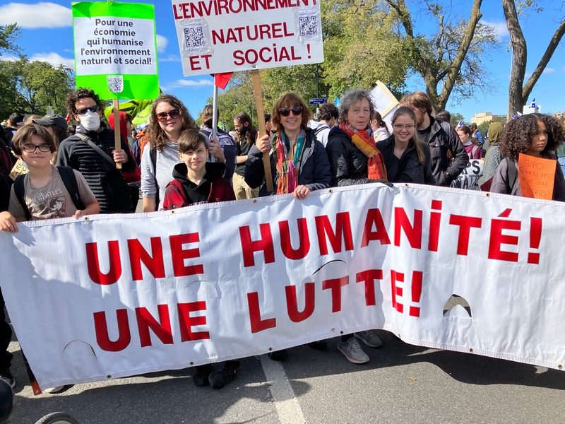Demonstrators at Climate Strike hold signs demanding climate justice, Montreal, QC September 23, 2022