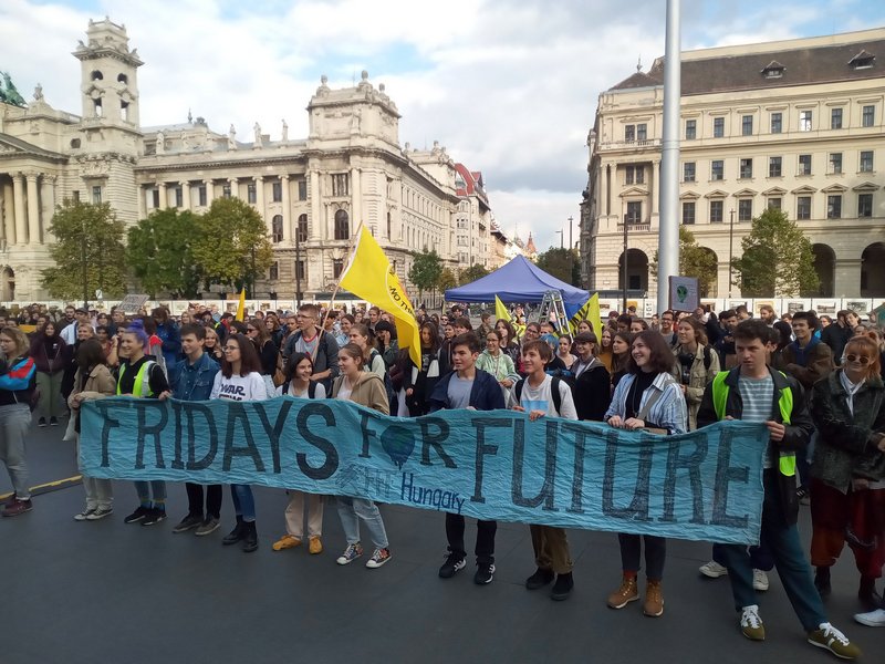 Demonstrators at Climate Strike hold signs demanding climate justice Budapest Hungary